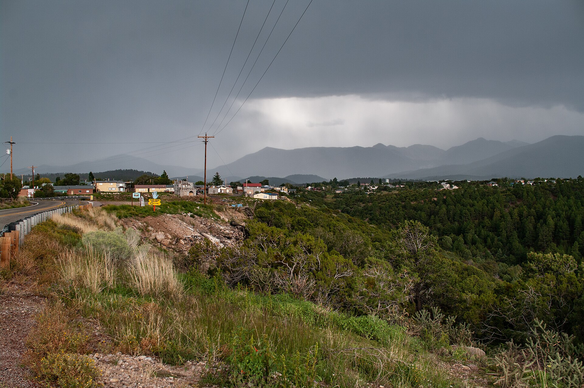 File:Looking east towards the town of Truchas in September of 2018. The Truchas Peaks of the Sangre de Cristo mountains are visible in the distance.jpg